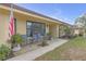 Charming front porch with seating and decorative plants and a US flag at 531 Gibson S Rd, Lakeland, FL 33813