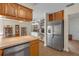 Open kitchen featuring a breakfast bar, tile flooring, and stainless steel refrigerator at 531 Gibson S Rd, Lakeland, FL 33813