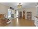 Spacious living room featuring tile floors, elegant chandelier, and ample display cabinets at 531 Gibson S Rd, Lakeland, FL 33813