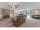 Bright living room with plush carpet, stone fireplace, and sliding doors to the backyard at 531 Gibson S Rd, Lakeland, FL 33813