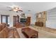 Cozy living room with a stone fireplace, wooden entertainment center and recessed lighting at 531 Gibson S Rd, Lakeland, FL 33813