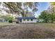 Exterior back of house with lots of green trees at 5420 Ivory Ln, Lakeland, FL 33811