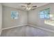 Bedroom with updated ceiling fan and two large windows at 5420 Ivory Ln, Lakeland, FL 33811