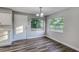 Bright dining area with new vinyl flooring, large windows, and stylish lighting fixture at 5420 Ivory Ln, Lakeland, FL 33811