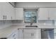 Bright kitchen featuring quartz countertops, subway tile backsplash, and modern stainless steel appliances at 5420 Ivory Ln, Lakeland, FL 33811