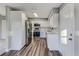 Modern kitchen featuring stainless steel appliances, stylish white cabinets, and luxury vinyl plank flooring at 5420 Ivory Ln, Lakeland, FL 33811