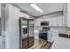 Modern kitchen featuring stainless steel appliances, stylish white cabinets, and luxury vinyl plank flooring at 5420 Ivory Ln, Lakeland, FL 33811