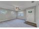 Inviting living room featuring plush carpeting, fresh neutral paint, and a modern ceiling fan at 5420 Ivory Ln, Lakeland, FL 33811