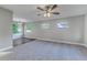 Open-concept living room with large windows, new carpet, and seamlessly connected dining area at 5420 Ivory Ln, Lakeland, FL 33811