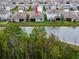 An aerial view of a home with a beautiful pond in the backyard of a residential neighborhood at 5431 Arlington River Dr, Lakeland, FL 33811