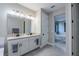 Bathroom featuring double sink vanity with granite countertops, leading into bedroom at 5431 Arlington River Dr, Lakeland, FL 33811