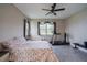 Comfortable bedroom with large window, ceiling fan, and exercise equipment at 5431 Arlington River Dr, Lakeland, FL 33811