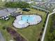 Aerial view of a stunning community pool with lounge seating and palm trees at 5431 Arlington River Dr, Lakeland, FL 33811