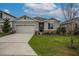 Charming single-story home with a two-car garage, manicured lawn and stone accents at 5431 Arlington River Dr, Lakeland, FL 33811