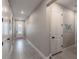 Bright hallway with tile flooring, white doors, and recessed lighting for a modern feel at 5431 Arlington River Dr, Lakeland, FL 33811