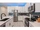 Contemporary kitchen featuring white cabinetry, stainless appliances, and a spacious quartz countertop at 5431 Arlington River Dr, Lakeland, FL 33811