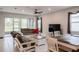 Inviting living room with a fan, tile flooring, and sliding doors to the screened lanai at 5431 Arlington River Dr, Lakeland, FL 33811