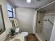 Bright bathroom with tiled shower, toilet, and vanity at 561 Lake Mystic Ln, Lakeland, FL 33813