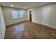 Bedroom boasts neutral tile flooring and an en-suite bathroom at 561 Lake Mystic Ln, Lakeland, FL 33813