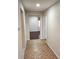 Inviting hallway features tile flooring, leading to a bedroom with hardwood floors at 561 Lake Mystic Ln, Lakeland, FL 33813