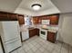 Spacious kitchen features wood cabinetry, white appliances, and tile flooring at 561 Lake Mystic Ln, Lakeland, FL 33813