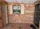 Cozy brick porch with exterior door and a window overlooking the front yard at 561 Lake Mystic Ln, Lakeland, FL 33813