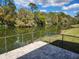 Paver patio with wrought iron fence offers serene views of the water at 561 Lake Mystic Ln, Lakeland, FL 33813