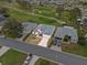 Aerial view of a charming single-story home with a well-manicured lawn, a two car garage, and a vibrant driveway at 5725 Mallard Dr, Lakeland, FL 33809