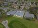 This is an aerial view of a single-story home on a golf course with a screened-in back porch at 5725 Mallard Dr, Lakeland, FL 33809