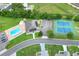 Aerial view of a community pool, hot tub, clubhouse, parking area, and tennis courts at 5725 Mallard Dr, Lakeland, FL 33809