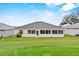 Expansive backyard with lush green lawn and views of the home's rear, including the bright sunroom at 5725 Mallard Dr, Lakeland, FL 33809