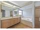 Bathroom featuring a large vanity, soaking tub, and glass shower at 5725 Mallard Dr, Lakeland, FL 33809