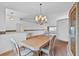 Bright dining area featuring a large window, chandelier lighting, and space for entertaining at 5725 Mallard Dr, Lakeland, FL 33809