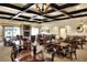 An elegant dining room offers a coffered ceiling with recessed lighting, a fireplace and ample seating for many residents at 5725 Mallard Dr, Lakeland, FL 33809