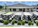 Community offers abundant golf carts parked outside the clubhouse with lush landscaping and ample parking for residents at 5725 Mallard Dr, Lakeland, FL 33809