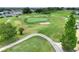 Aerial shot of the golf course with well-maintained fairways, greens, sand traps and a meandering cart path for players at 5725 Mallard Dr, Lakeland, FL 33809