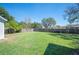 Expansive, green backyard features wood fencing and mature trees for privacy at 624 Woodward St, Lakeland, FL 33803