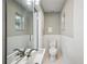 Bathroom featuring pedestal sink, toilet, tiled walls, and mirror at 624 Woodward St, Lakeland, FL 33803