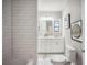 Bathroom featuring subway tile, a bathtub, marble countertop, and white cabinets at 624 Woodward St, Lakeland, FL 33803