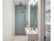 Bathroom featuring walk-in shower, modern fixtures, rain shower head and blue accent wall at 624 Woodward St, Lakeland, FL 33803