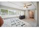 Spacious bedroom featuring large windows, light grey walls, carpet and ceiling fan at 624 Woodward St, Lakeland, FL 33803