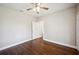 Bedroom featuring hardwood floors, ceiling fan, and an ensuite bathroom at 624 Woodward St, Lakeland, FL 33803