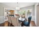 Bright dining room features hardwood floors, stylish chandelier, and views into the living room and backyard at 624 Woodward St, Lakeland, FL 33803