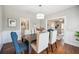 Dining room with hardwood floors, wainscotting, and a view into the living room at 624 Woodward St, Lakeland, FL 33803