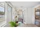 Bright entryway featuring multiple doors, textured walls, neutral tones, and view to sunroom at 624 Woodward St, Lakeland, FL 33803