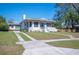 Charming single story home with light blue door, white trim, and driveway leading to an attached carport at 624 Woodward St, Lakeland, FL 33803