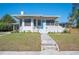 Charming single story home with light blue front door, mature landscaping, and a classic architectural design at 624 Woodward St, Lakeland, FL 33803