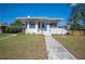 Lovely single-story home showcasing a tidy lawn, attractive landscaping, and a welcoming light blue front door at 624 Woodward St, Lakeland, FL 33803