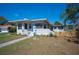 Charming single-story home featuring a manicured lawn, light blue door, and decorative exterior lighting at 624 Woodward St, Lakeland, FL 33803