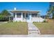 Inviting single-story home with a well-kept front yard, a unique roofline, and a quaint picket fence at 624 Woodward St, Lakeland, FL 33803
